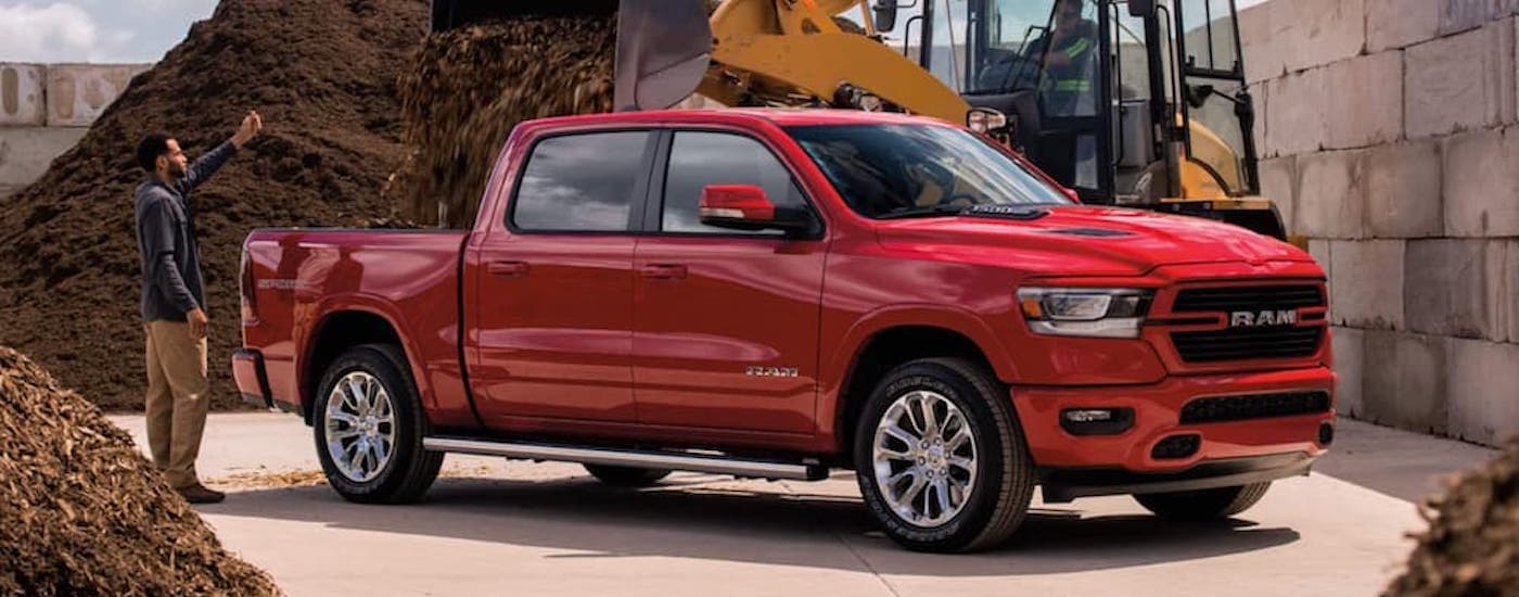 Red 2021 Ram 1500 parked at an angle on a jobsite