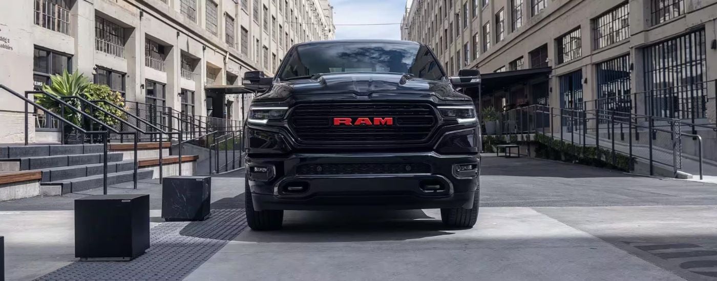 Black 2023 Ram 1500 Limited parked in a city