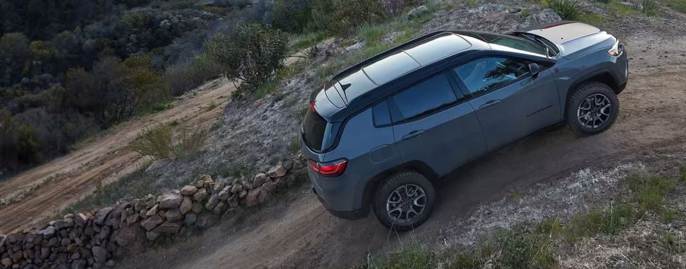 Grey 2025 Jeep Compass Trailhawk driving off-road