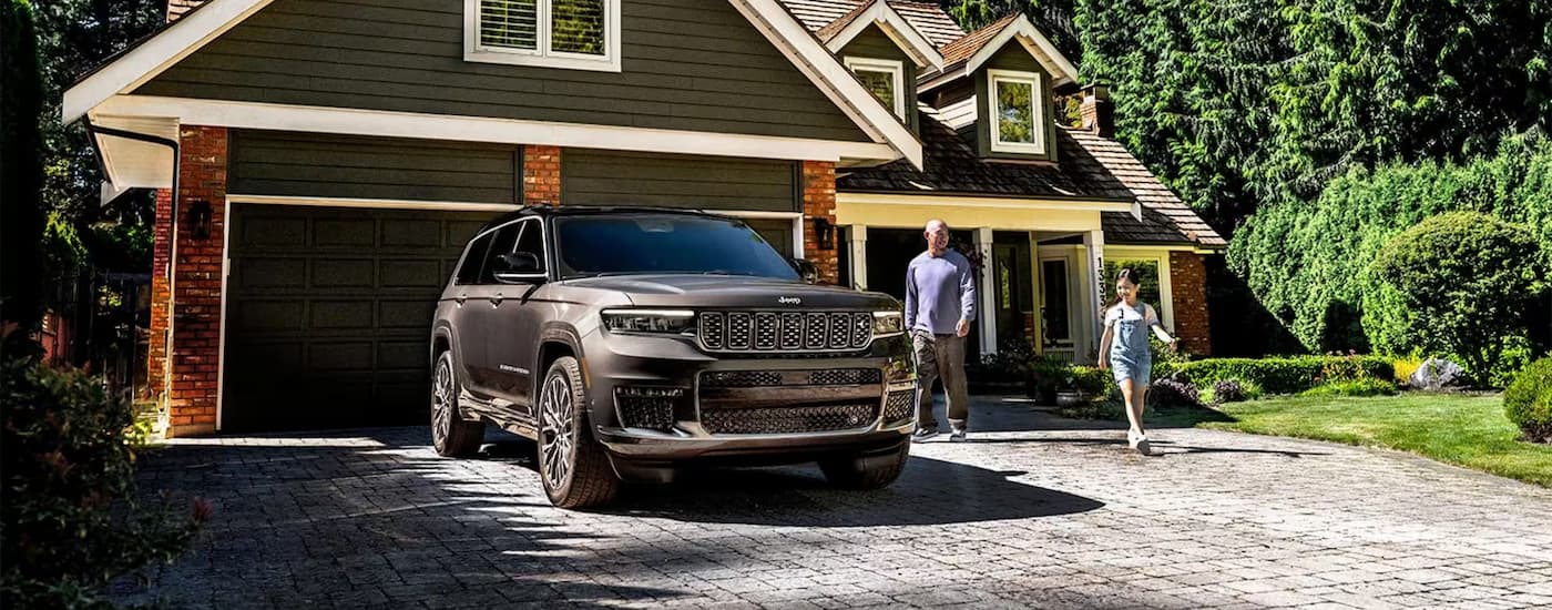Grey 2025 Jeep Grand Cherokee parked in a driveway