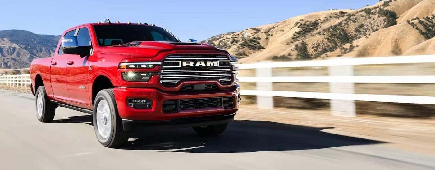 Red 2026 Ram 2500 LARAMIE driving on an open road