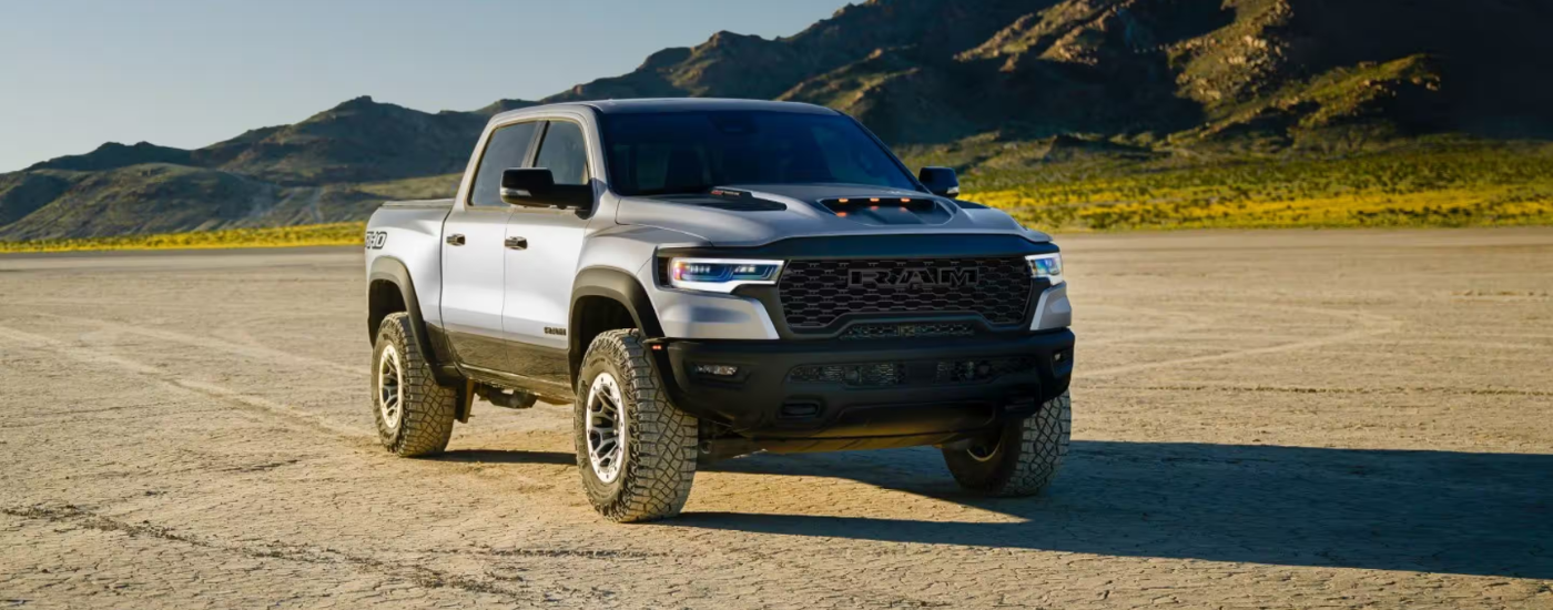 Silver 2027 Ram 1500 RHO parked off-road at an angle