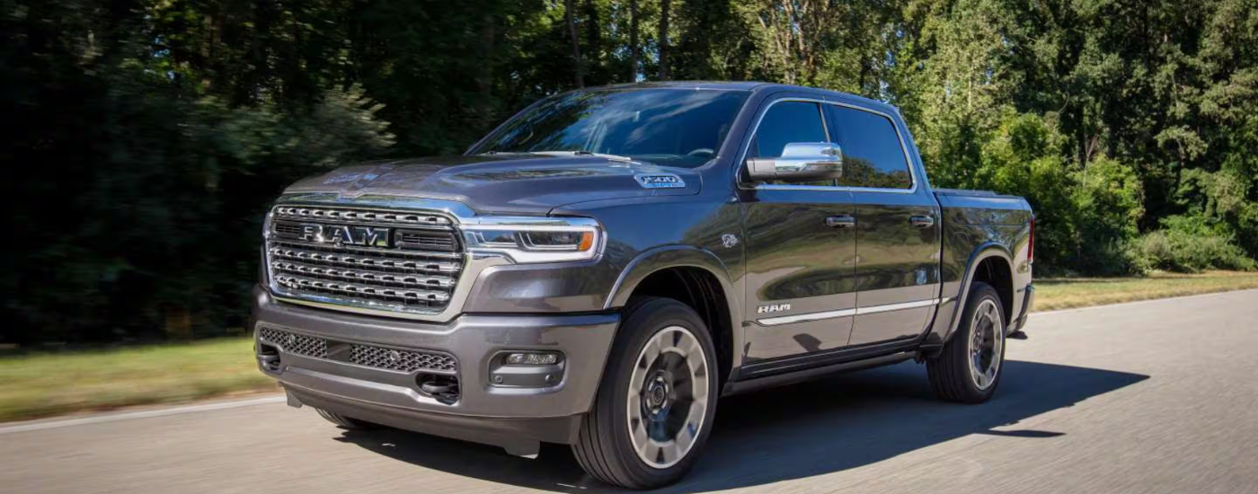Grey 2027 Ram 1500 driving down a woodland road