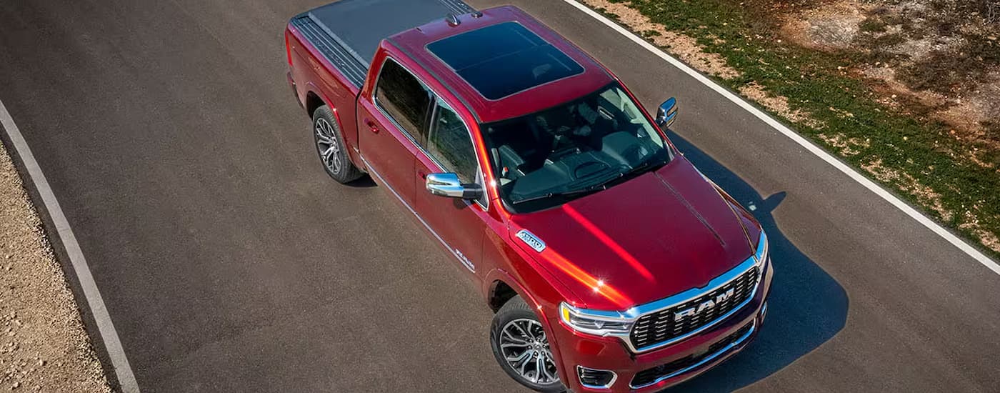 Red 2025 Ram 1500 for sale parked at a dealership