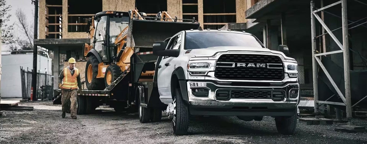 A white 2023 Ram 3500 Chassis Cab at a construction site.