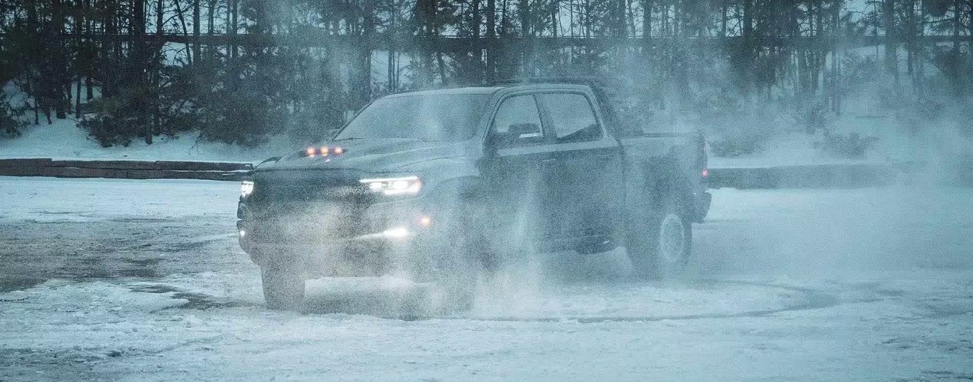 Black 2023 Ram 1500 TRX doing donuts near a Ram dealer near Wixom