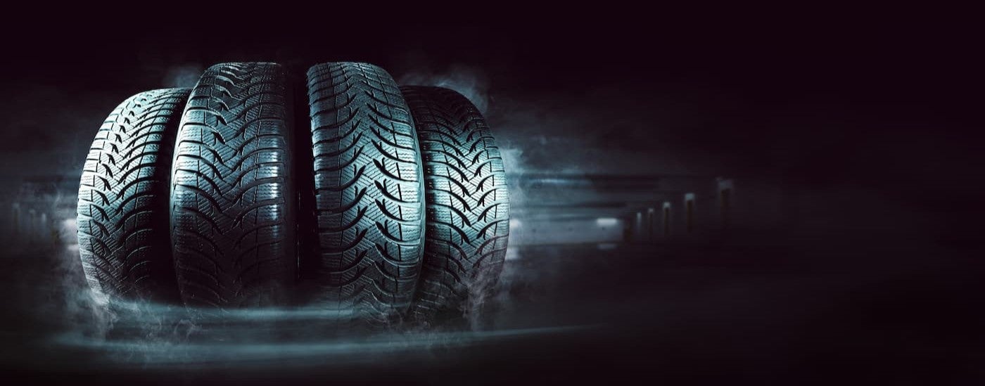 Four tires lined up side by side.