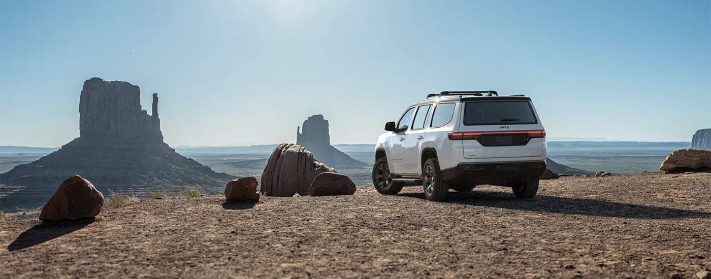Rear view of a white 2026 Jeep Grand Wagoneer in the desert.
